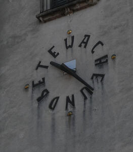 Clock face on church with letters instead of numbers: WACHE UND BETE (watch and pray)