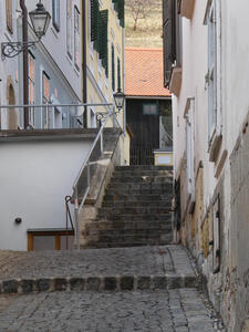 narrow staircase with lamp at left