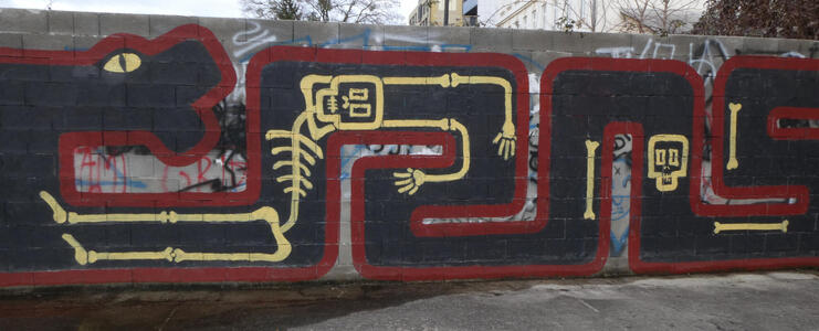 graffiti snake devouring skeletons