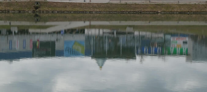 modern buildings reflected in water