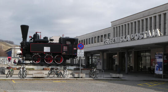 old locomotive in front of train station