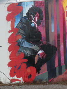 graffiti seated man with black helmet