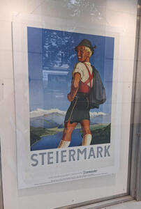 Poster with blond-haired man in green cap and lederhosen; text is Steiermark