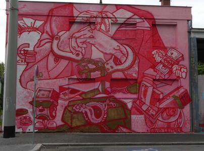 Person with hands folded, wearing what appear to be handcuffs; at right a stack of cash with wings on it, at lower left, a stack of cash wearing sunglasses.