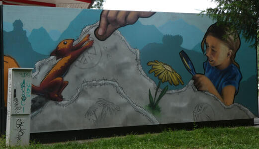 Person feeding a squirrel; girl with magnifying glass looking at yellow flower.