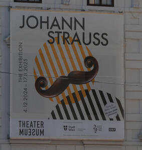 Poster for Johann Strauss exhibit; shows stylized circles as a head and body, with a moustache on the head circle.