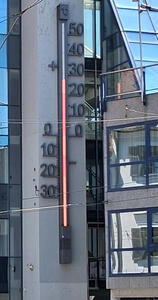 large thermometer on side of building
