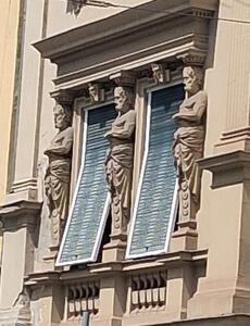 three statues of men
