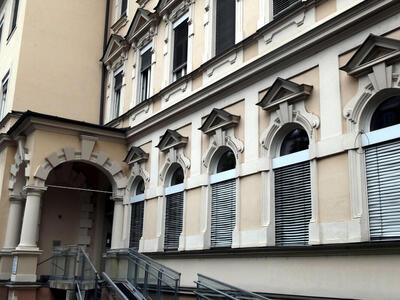 Series of windows with semicircular area above rectangular area, and a triangular stone section above that.