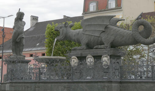 sculpture of person preparing to slay a dragon