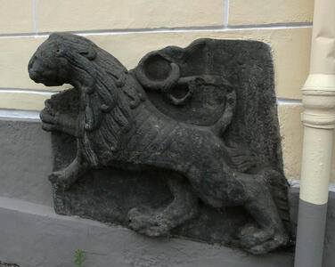 carved lion on side of building