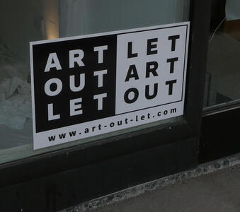 At left: ART OUT LET; at right: LET ART OUT