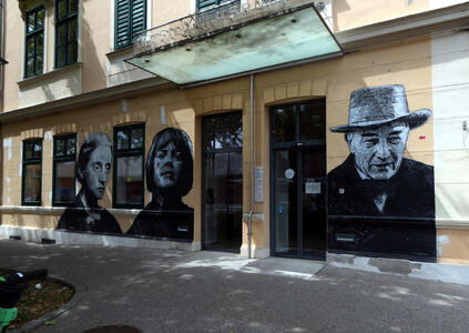 Black and white drawings of authors on museum wall