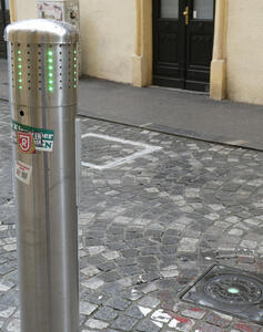 Stanchion retracted into ground; green light on post.