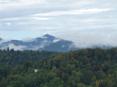 Low-floating clouds with mountains in background