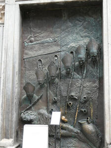 Door with 3-D relief of six people wearing bishop’s mitres.