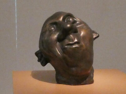 sculpture of mans head with distorted features