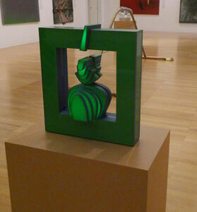 Green glass sculpture that has multiple “slices” of curved glass