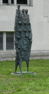 abstract sculpture resembling three tall people