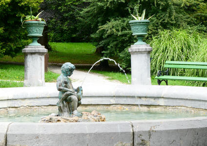 Fountain with sculpture of boy riding a fish that is spouting water