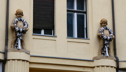 cherub like figures holding wreaths