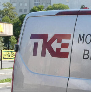 Truck for TKE company. The K and E are joined so that the space between them looks like an arrow pointing to the left. The negative space around the T looks like an elevator.