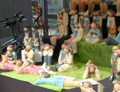 Ceramic figures of people relaxing, sitting, and being happy