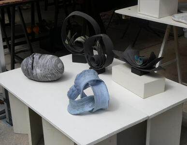 Black, gray, and blue ceramics in abstract shapes.