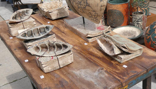 Ceramics in shape of boks with curled pages.