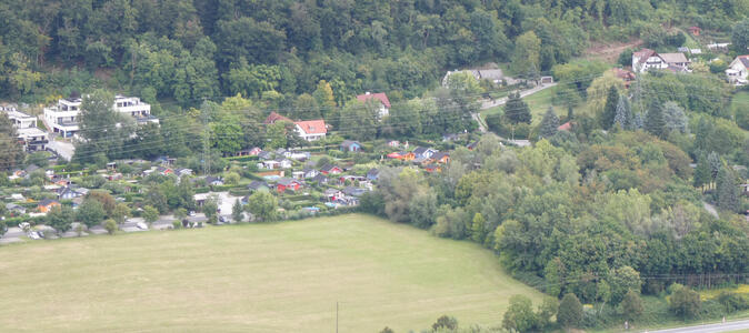 View with large field in left foreground, trees at right