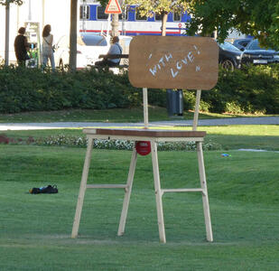 An oversized replica (perhaps 2.5 meters tall)  of a child’s chair