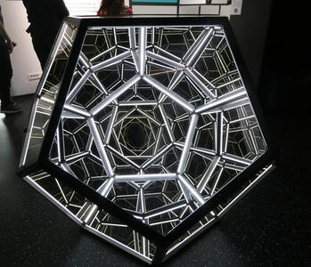 mirrored polyhedron with pentagonal faces; appears to recede to infinity
