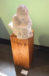 Sculpture of child playing with clay