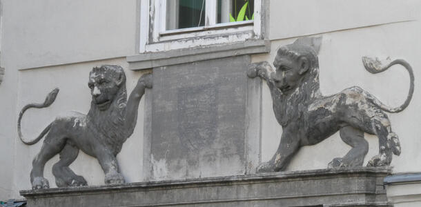 Two carved lions above an archway