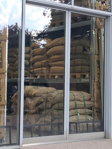Warehouse with stacks of large bags of coffee beans
