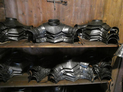 Shelves with stacked shoulder armor segments