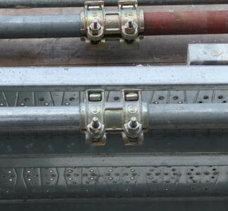 Artistic-looking pipes screwed together in a scaffold.