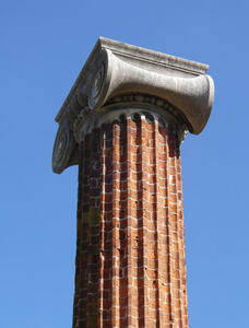 Fluted brick column with a stone column top.