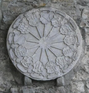 Thirteen heraldic shields arrayed in a circle