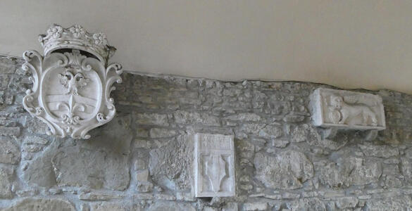 Heraldic images attached to brick wall