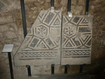 Segments of mosaic floors with geometric designs on them