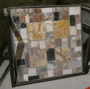 Multicolored rectangular stones of various sizes filling a square frame