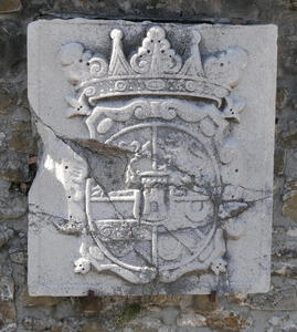 Stone coat of arms with a chunk missing in the center left.