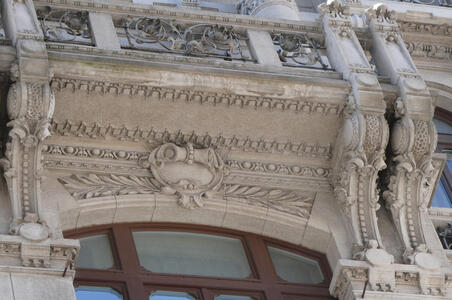 Closeup showing scrollwork on underside of balcony