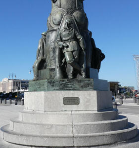 Statue of soldier Francesco Paglia at base of large pole