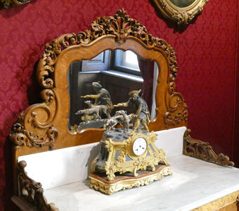 Desk clock; decoration on top is a statue of a man with two dogs that appear to be hunting dogs