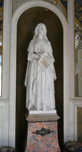 Statue of woman singing; she has a (sculpted) sheet of music in her hand