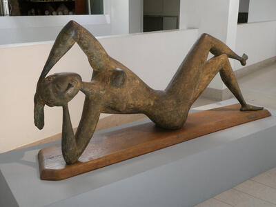 Abstract stone sculpture of reclining woman