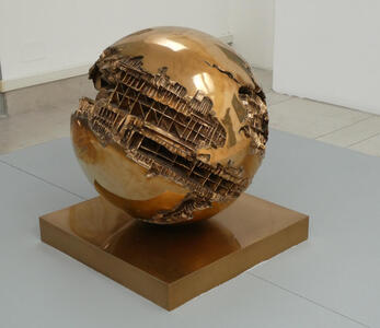 Large brass sphere with portions etched away to “reveal” internal scaffolding