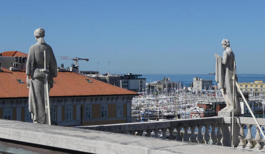 Top level of museum. Shows rear view of two statues with metal support rods
